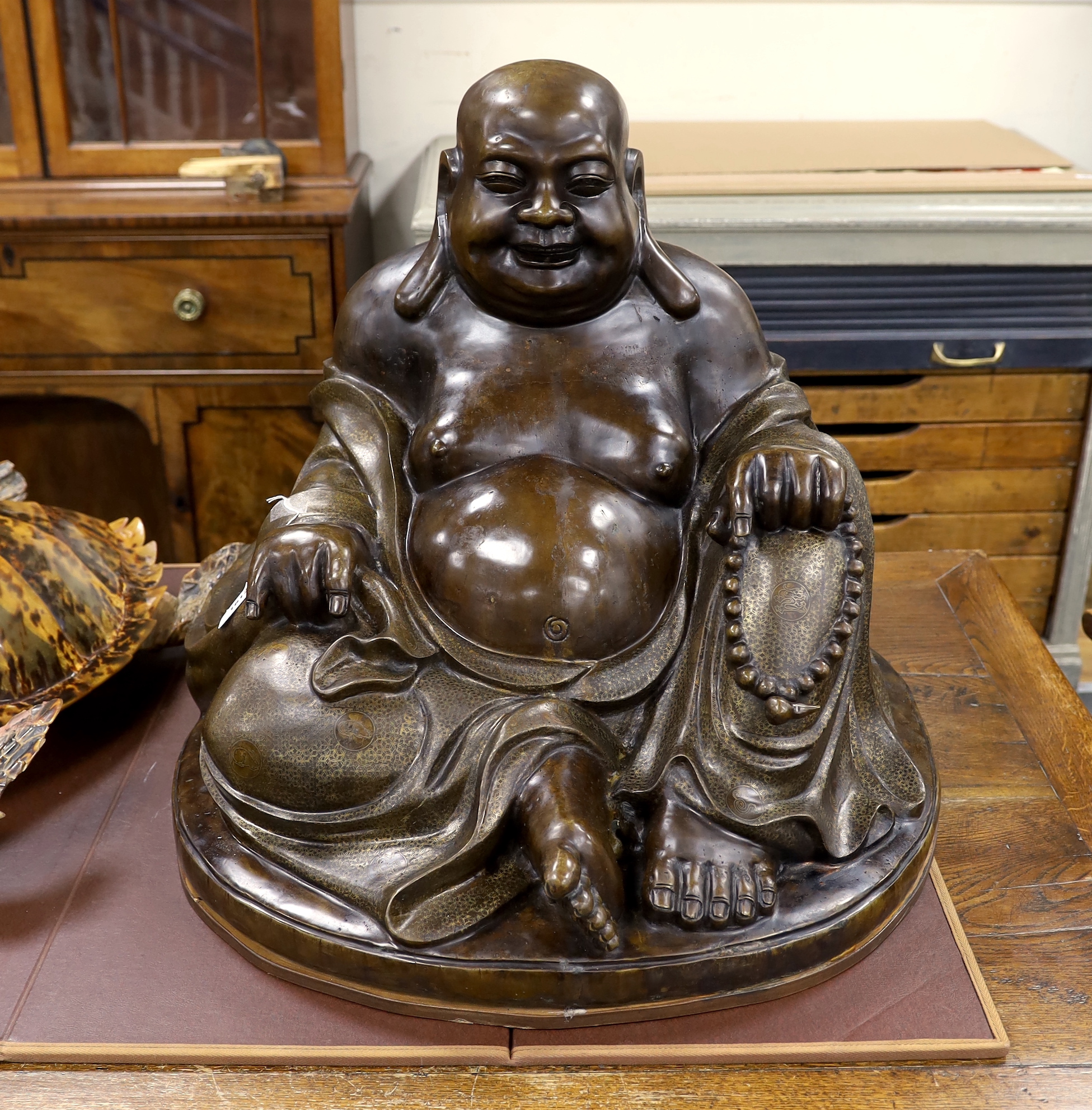 A massive Chinese bronze seated figure of Budai, 62cm high